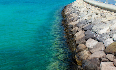 Beautiful stone beach and tropical turquoise blue sea. View from above. Concept.