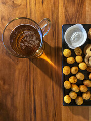 Chicken snack balls and beer on wooden table background