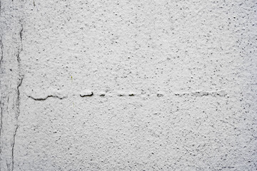 Texture of a concrete wall with cracks and scratches which can be used as a background