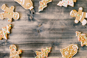 Christmas homemade gingerbread cookies with cinnamon and anise on old wooden background frame with space for text. Merry Christmas and Happy New Year. Xmas concept. Top view. Copy space.
