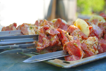 pieces of raw pork on skewers, selective focus
