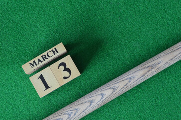 March 13, Number cube With a snooker stick on a green background, snooker table.	
