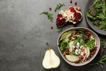 Tasty salad with pear slices and fresh ingredients on grey table, flat lay. Space for text