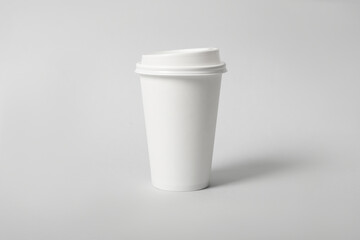 Takeaway paper coffee cup on light grey background