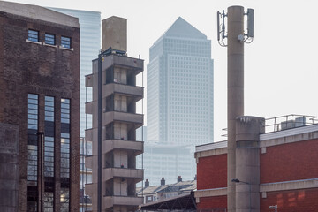 Skyscraper One Canada Square in Canary Wharf seen through old industry buildings in Poplar, East London