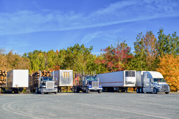 Trucks parked with New England foliage background. Holiday concept
