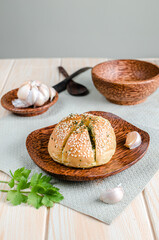 Korean Garlic Bread on Wood plate with Garlic Wood Background
