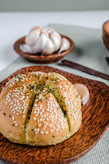 Korean Garlic Bread on Wood plate with Garlic Wood Background
