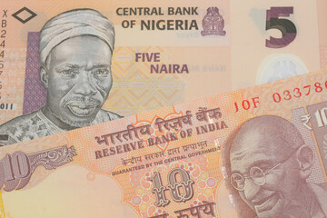 A macro image of a orange ten rupee bill from India paired up with a orange, plastic five naira note from Nigeria.  Shot close up in macro.
