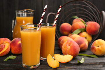Natural peach juice and fresh fruits on black wooden table