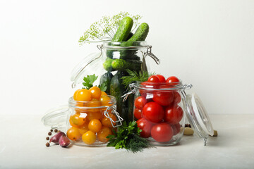Pickling jars with fresh vegetables on light table