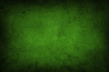 Green cracked concrete textured wall background. Dark edges
