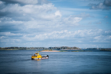 Fototapeta premium Yellow steamer, river, cold sky, Volga river