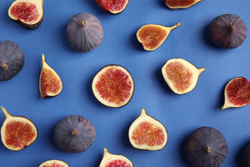 Delicious ripe figs on blue background, flat lay
