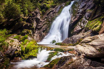 Obraz premium Beautiful waterfall in the forest, autumn water stream in bohemian forest, czech republic