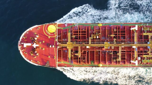 Oil tanker (LPG or chemical) is floating at sea oil port terminal. Oil and gas petrochemical tanker offshore in open sea. Refinery industry cargo ship. Aerial top down view