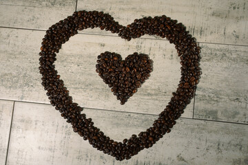 coffee beans hearts on wooden background