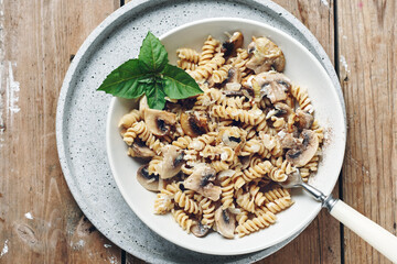 Fusilli pasta with mushrooms and cheese.