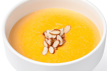 Bowl of pumpkin soup isolated on white