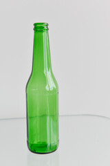 Beer bottle and glass reflections. Empty beer bottle isolated on white background.