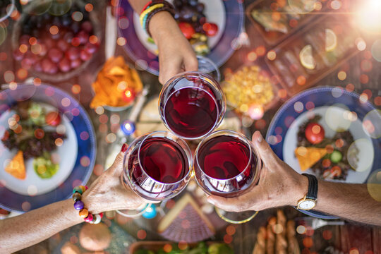 Family Dinner For A Celebration With Red Wine And Cheers