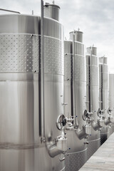Modern stainless steel barrels for wine fermentation at a winery. Wine industry.
