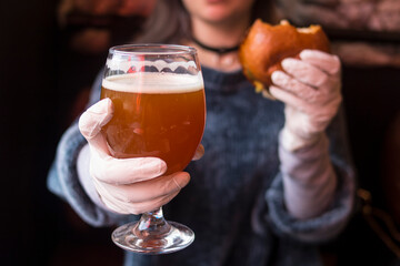 Girl with glass of beer and burger