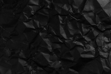 Blank crumpled and straightened black paper with wrinkles