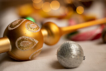 The atmosphere of Christmas and New Year. Decoration for the Christmas tree on the background of garland lights