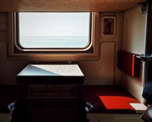 View from the window of an old train to the sea on a sunny day