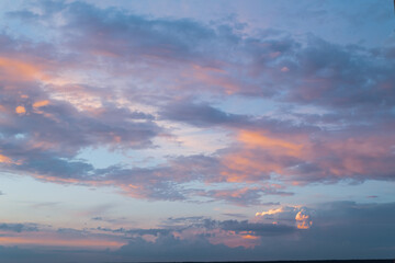 Colorful cloudy sky at sunset. Beautiful color transitions. Abstract background of nature.
