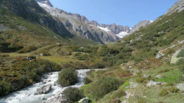 Chelen river in Chelen valley with beautiful mountains in background in Swiss Alps close to Goschenen