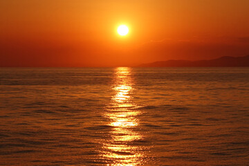 Beautiful romantic sunset with golden colours over the Aegean deep blue sea