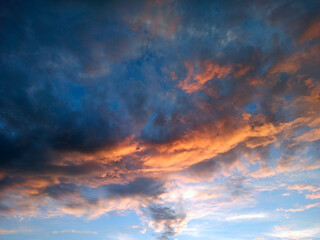 Evening landscape with dark clouds during sunset. Decline with bright clouds