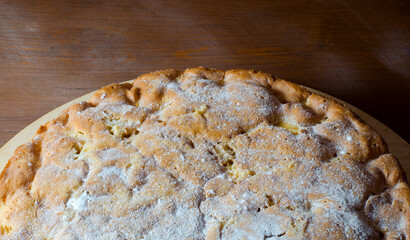 Baked homemade apple pie on the dark wooden background