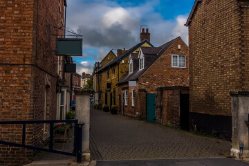 A view down a traditional quaint street in Melton Mowbray, Leicestershire, UK in the summertime