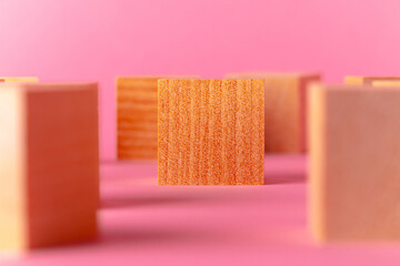 Toy wooden cubes with copy space against pink background