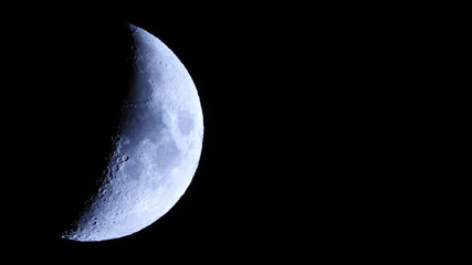 Extreme zoom of half moon as seen at night