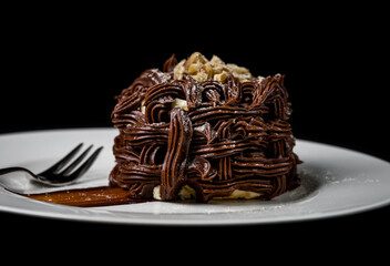 Kiev cake with nuts and chocolate. Close-up photography in a restaurant. Sweet delicious dessert of Russian cuisine.