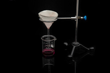 Filter paper in laboratory. Scientists are chemical filtration by filtering through filter paper in...