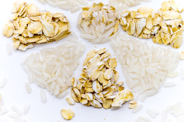 Oatmeal and rice on a white background. Rice and porridge. Flower of cereals.