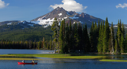 Panorama of canoers on Sparks Lake under Broken Top in Oregon
