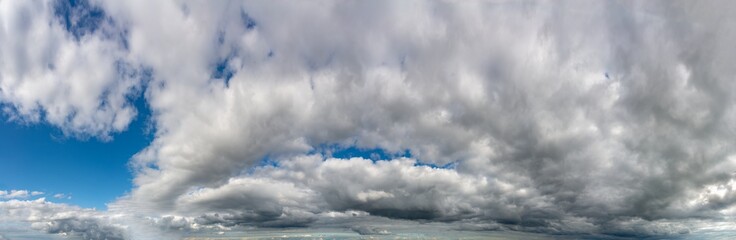 Fantastic clouds against blue sky, panorama
