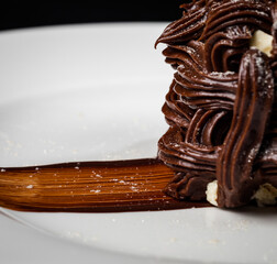 Kiev cake with nuts and chocolate. Close-up photography in a restaurant. Sweet delicious dessert of Russian cuisine.