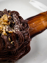 Kiev cake with nuts and chocolate. Close-up photography in a restaurant. Sweet delicious dessert of Russian cuisine.
