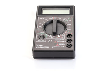 Digital electrical tester multimeter in black case isolated on white background. Digital multimeters have a numeric display, can measure voltage, current and resistance. Close-up. Full depth of field.