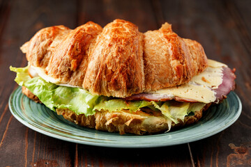 Croissant stuffed with bacon, cheese and lettuce