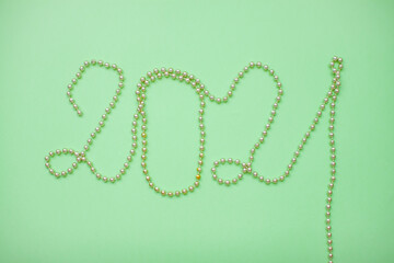 Happy New year 2021 celebration. Inscription 2021 from gold shiny new year beads