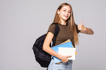 Young student woman with backpack bag holding hand with thumb up gesture, isolated over white...
