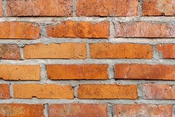 Obraz premium Wall of red ceramic bricks, background close up